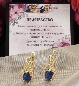 Сребърни обеци със стилизирана безкрайност и син циркон с 18 каратово злато