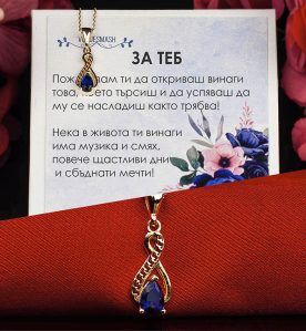 Сребърно колие със стилизирана безкрайност и син циркон с 18 каратово злато